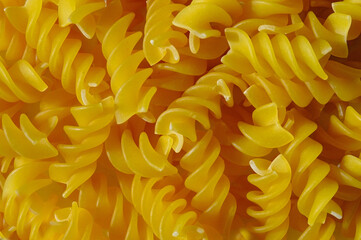 full grain spiral pasta on white background, top view. close up.