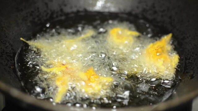 Indian kanda bhaji frying in hot oil, India street food.