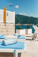 Blue beach towel on sun loungers on the beach near the sea.