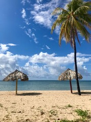 Peaceful and relaxing travel destination in Cuba (Caribbean): Dreamlike Playa Ancon with white sand, turquoise ocean and blue sky is an idyllic vacation paradise