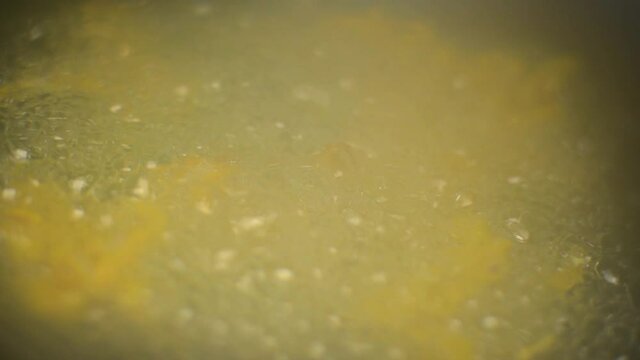 Close up shot of frying pakoras in hot oil, Mumbai's street food in India.