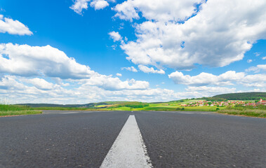 Asphalt Road scenery background with sunny blue cloudy sky