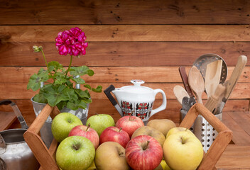 Group of different fresh apples ready to be sold. Wooden basket and rustic background. Farmer's harvest