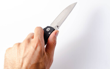 A folding knife with a black handle on a white background, open and closed. Paracord lanyard on the knife. Tactical folding knife in close-up. Knife in a man's hand