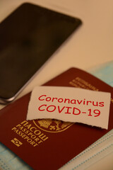 Travel ban concept with passport and mobile phone
