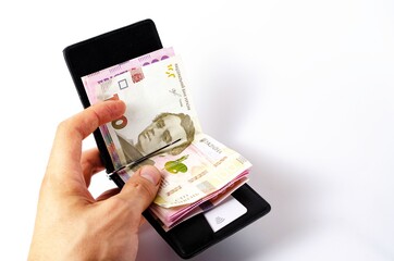 Banknotes Ukrainian hryvnia and dollars on a white background in close-up. Money in a black wallet, money clip Dollars and hryvnia
