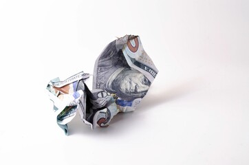 Crumpled, burnt dollar bills on a white background in close-up and in a man's hand