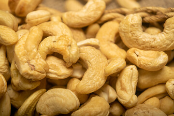 Cashew nuts scattered surface texture. Close up.
