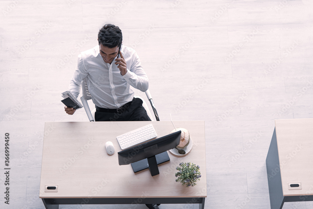 Poster top view of executive, manager, or engineer drinking coconut juice working on computer using smartph