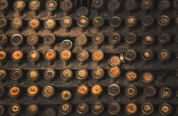 circle buttons of old type writer matchine in dark light.