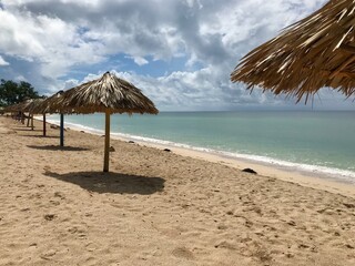 Peaceful and relaxing travel destination in Cuba (Caribbean): Dreamlike Playa Ancon with white sand, turquoise ocean and blue sky is an idyllic vacation paradise
