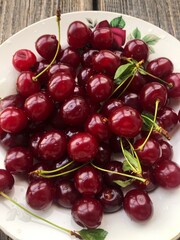 Ripe cherries in a white plate macro