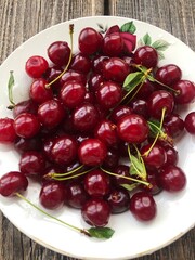Ripe cherries in a white plate macro