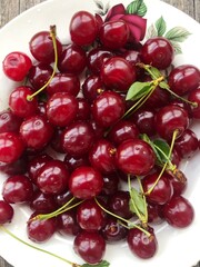 Ripe cherries in a white plate macro