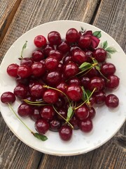 Ripe cherries in a white plate macro