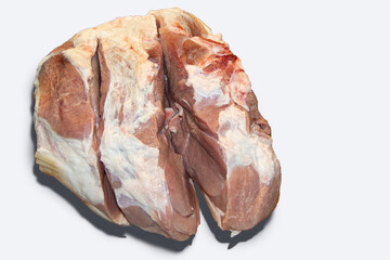 A large piece of raw pork ham cut is not completely cut. On a white background. Isolated