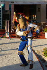 dancer in ethnic costume with a bag on his head - no face