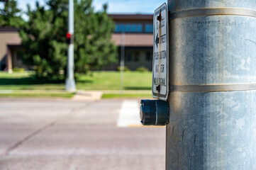 Push button at cross walk busy street intersection in a city
