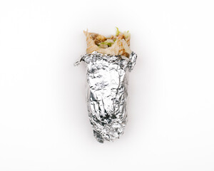 Bitten Durum kebab in foil paper