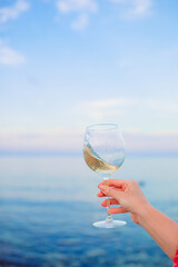 Glass of white wine on tropical beach