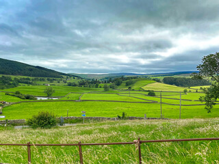Fototapeta na wymiar Landscape view, of fields, meadows, hills and trees, on a cloudy day near, Appletreewick, Skipton, UK