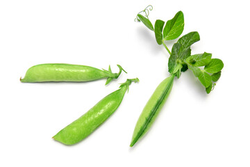 Pods of green peas with leaves on a white isolated background.