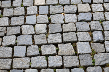 Stone pavement texture. Granite cobble stoned pavement background.