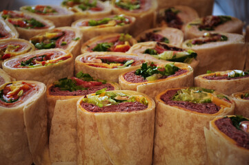 A tray of wraps filled with meat and vegetables
