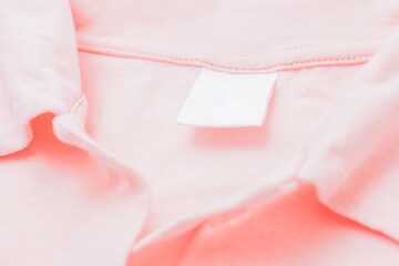 Close up blank white label on a pink t-shirt