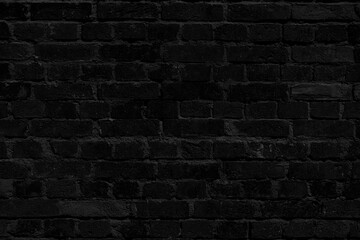 Black brick wall. Loft interior design. Black paint of the facade.