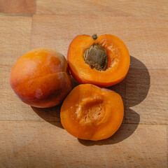 Naklejka na ściany i meble Fresh apricot on rustic, wooden table