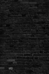 Fototapeta na wymiar Black brick wall. Loft interior design. Black paint of the facade.