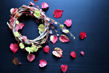 Autumn background with vibrant fall leaves on black, a design template with a place for text