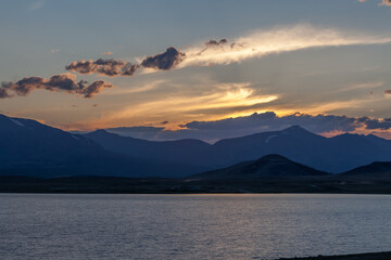 Mountain landscape at sunset. Outstanding view of the mountain ridges and clouds. Mountain Lake in Altai of Mongolia