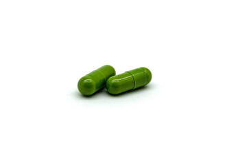 Two green medicinal capsules