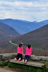 Girls on Mountain Top looking in Distance