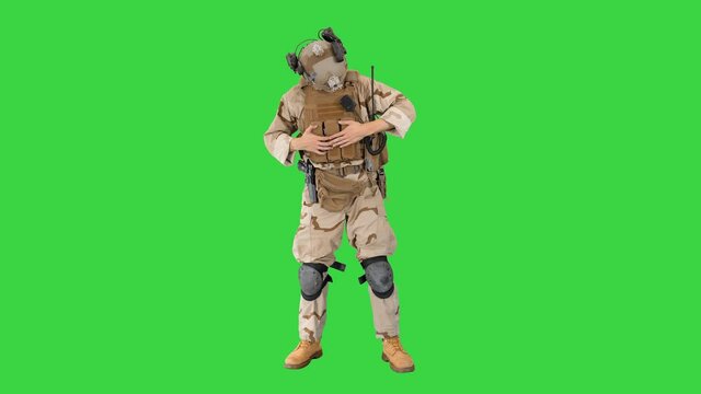 Soldiers in camouflage gear checking ammunition on a Green Screen, Chroma Key.