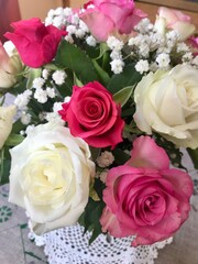 Obraz na płótnie Canvas Beautiful festive flower bouquet arrangement of a bunch of fresh pink and white roses celebrating the happy occasion of a birthday or anniversary at home