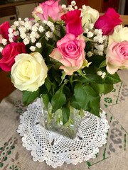 Beautiful festive flower bouquet arrangement of a bunch of fresh pink and white roses celebrating the happy occasion of a birthday or anniversary at home