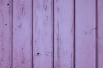 Wooden background of lilac-colored vertical planks. Cheerful 70s retro color. 