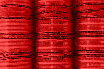 Close-up of pile of hair curlers. Red curlers.  Background texture of plastic hair curlers or rollers in red color  for styling hair, full frame overhead close up view