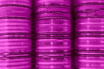 Close-up of pile of hair curlers. Purple curlers.  Background texture of plastic hair curlers or...