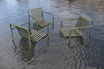 flooded metal chairs in the street