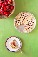 Homemade sweet cherry pie on a green background.