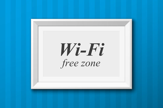 The inscription &quot;Wi-Fi, free zone&quot; in the picture frame on the blue wall