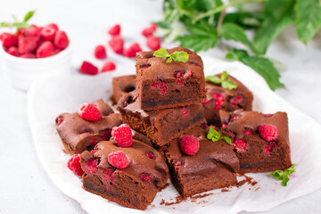 Chocolate brownie with berries and mint leaves