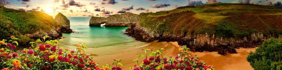 Vivid landscape of beach and coast with mountains and vegetation.Stunning scenery of coastline, beach and cliffs in Cantabria, Spain - obrazy, fototapety, plakaty