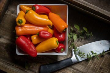 fresh peppers on wooden tray