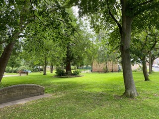 Small area of parkland, with old trees and grass, in the centre of, Burley in Wharfedale, Ilkley, UK
