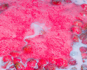 Fototapeta premium froth on strawberry jam, top view